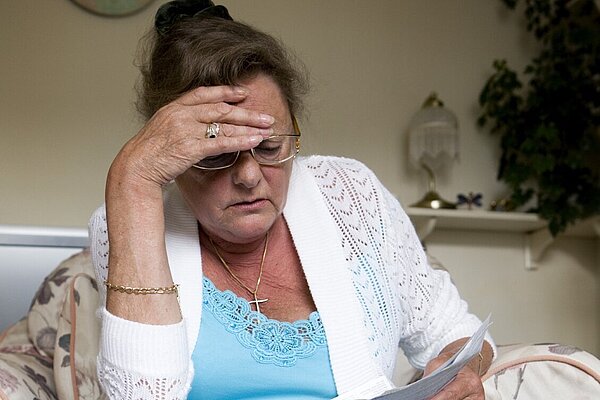 Concerned lady looking at letter