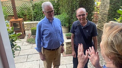 Peter Allen & Philip Browne talk to a local resident on their doorstep