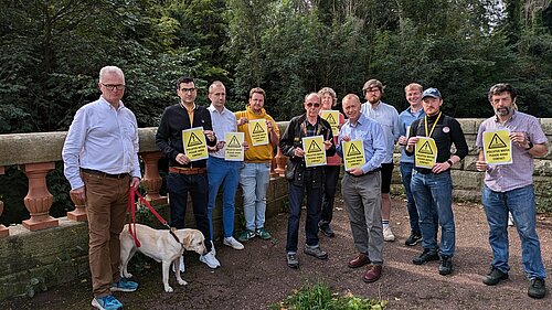 Tim, Peter and other Lib Dem campaigners holding pollution warning signs